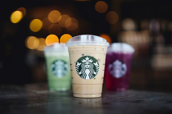 Several Starbucks beverages on a countertop.