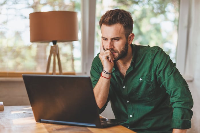 Man at laptop with serious expression