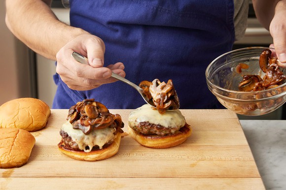 Man preparing mushroom burgers