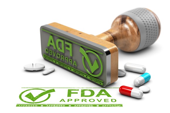 A stamp marked "FDA Approved" is shown next to a few pills.