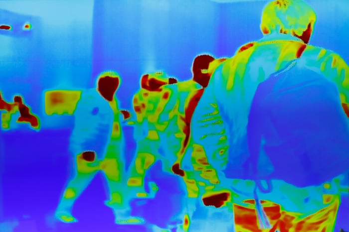 Crowd of people viewed as thermal images.