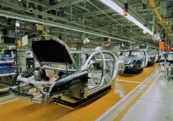 auto assembly plant showing car bodies lined up on assembly line