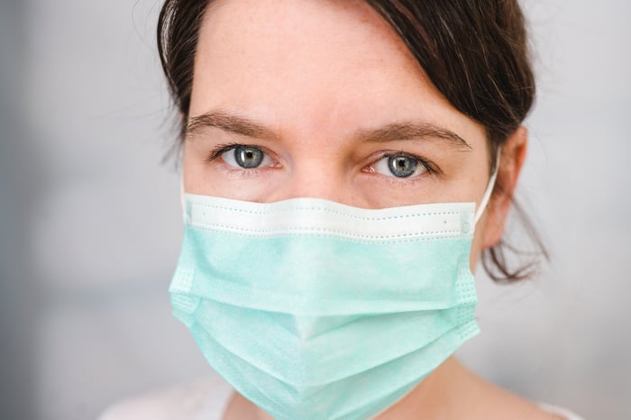 An up-close view of a woman wearing a face mask.