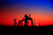 A natural gas well with pipelines at sunset.