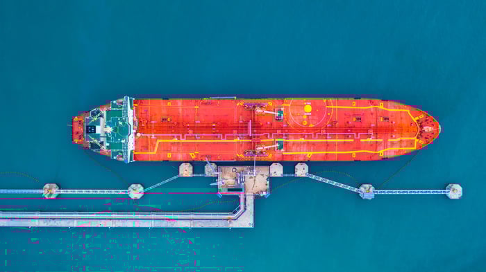 An oil tanker docked and being filled