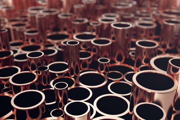 A large collection of copper pipes sitting on their ends