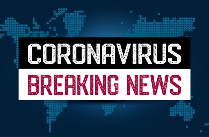 "Coronavirus breaking news" in capital letters over top of a digital world map