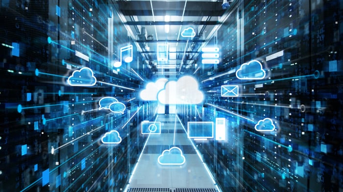 A cloud in the middle of a data center that's connected wirelessly to a number of devices.