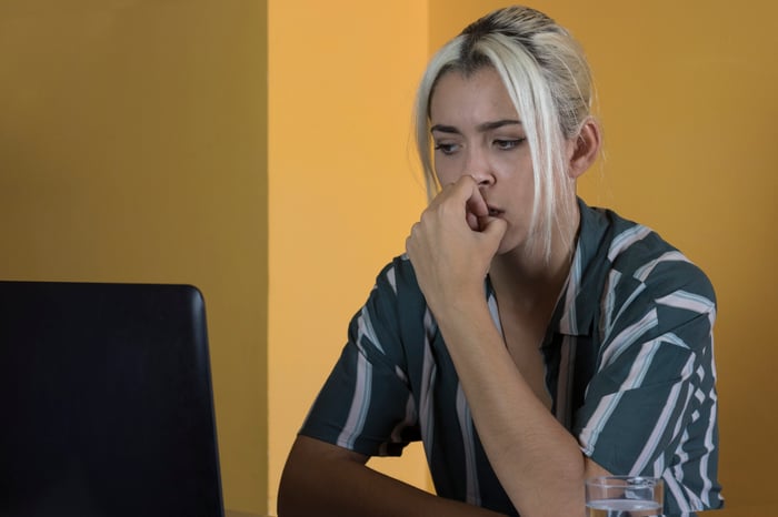 Woman at laptop biting her nails