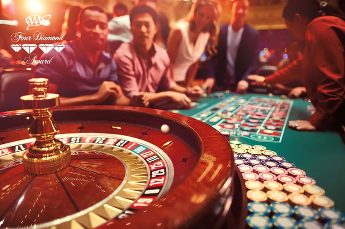 Gamblers at a roulette wheel.