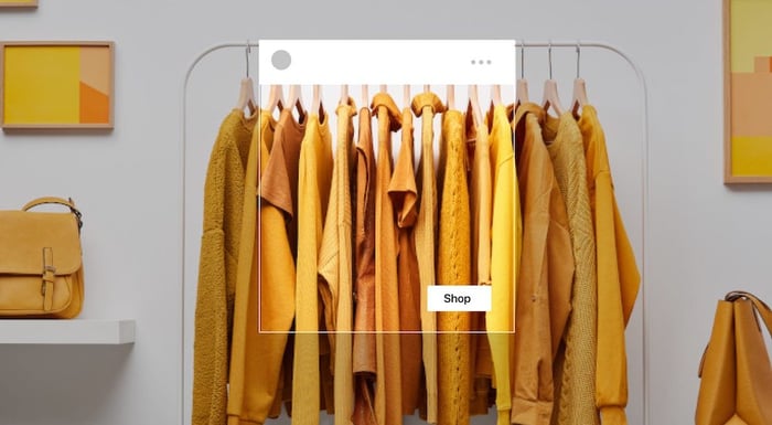 A bunch of yellow dresses on hangers, highlighted with a 