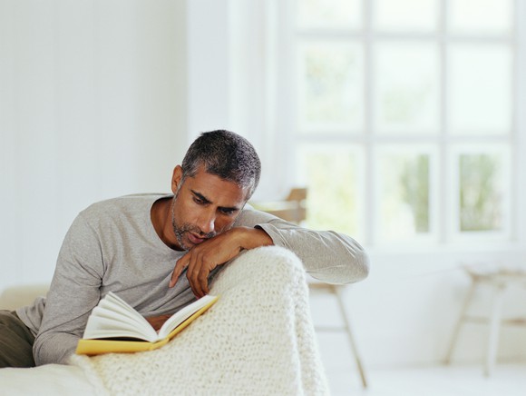 Middle-aged man reading book