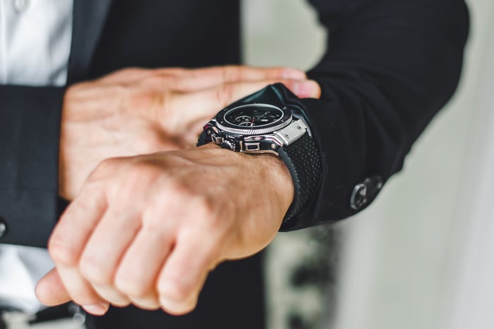 A man looking at his wrist watch