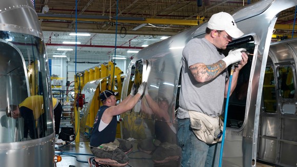 Assembly workers working on an Airstream vehicle.