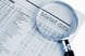 Magnifying Glass Newspaper Stock Market Top Stock Buy Sell Getty