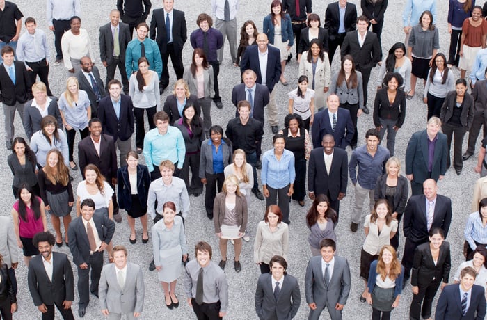 A large, diverse crowd of people standing together.