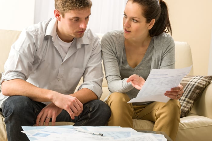 Worried young couple discussing finances.