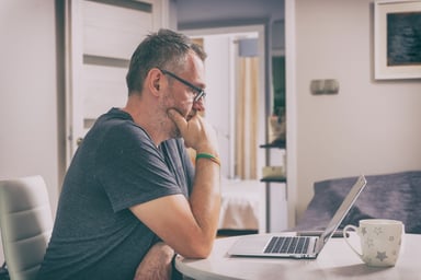 Older man with serious expression staring at laptop_GettyImages-1176550938