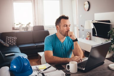 Man at laptop resting fist on chin_GettyImages-624128428