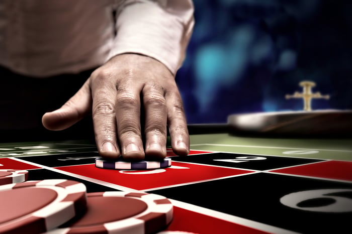 Gambler betting by placing a chip on a roulette table