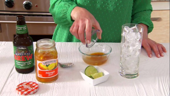 A person making drinks from Smuckers products.