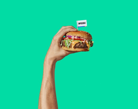 Person holding an Impossible Burger sandwich.