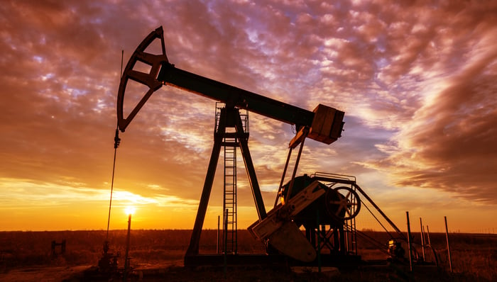 An oil pump with a dramatic sunset in the background.