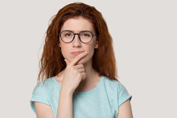 Woman with glasses thinking