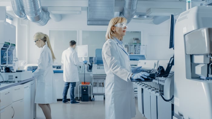 People in lab coats working in a laboratory. 