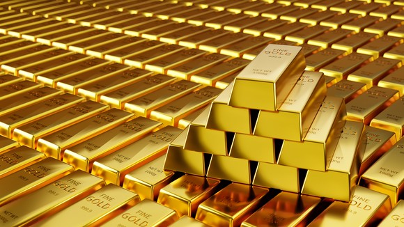 A pyramid of gold bars sits on rows of other gold bars.