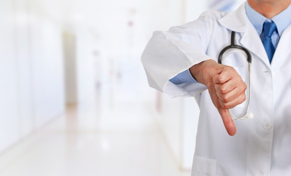 Doctor giving a thumbs down.