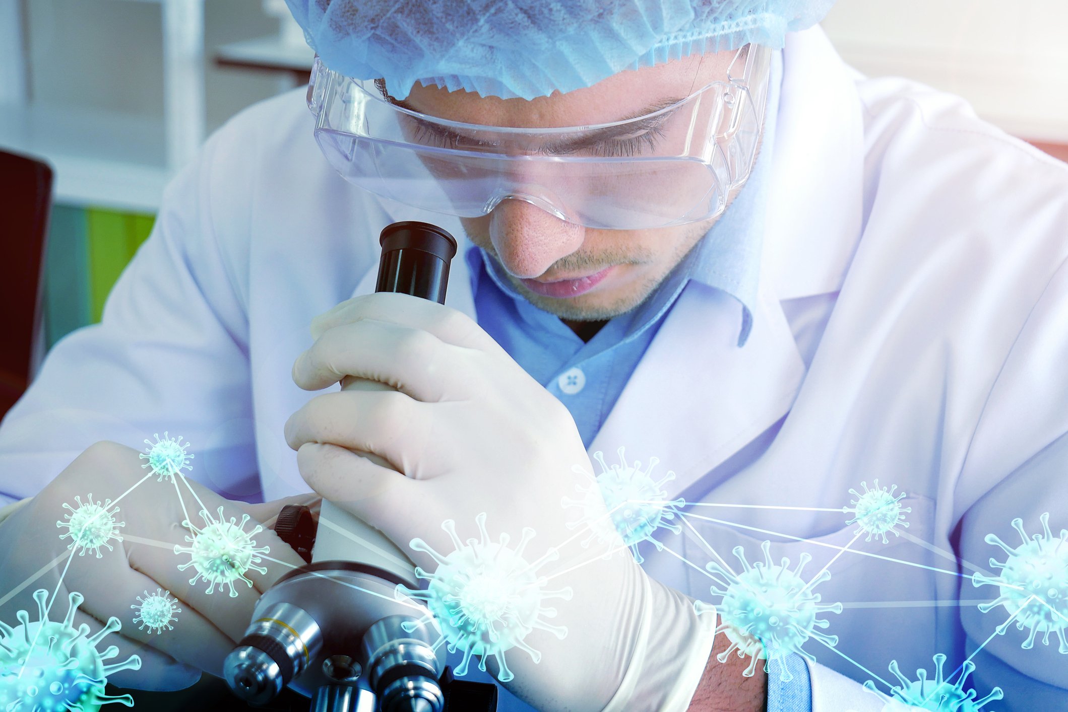 Scientist looking through microscope with coronavirus