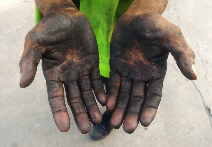 A pair of hands stained with oil