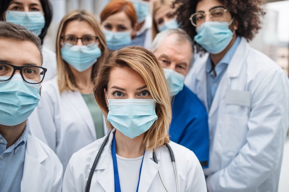 Group of doctors with face masks looking at camera