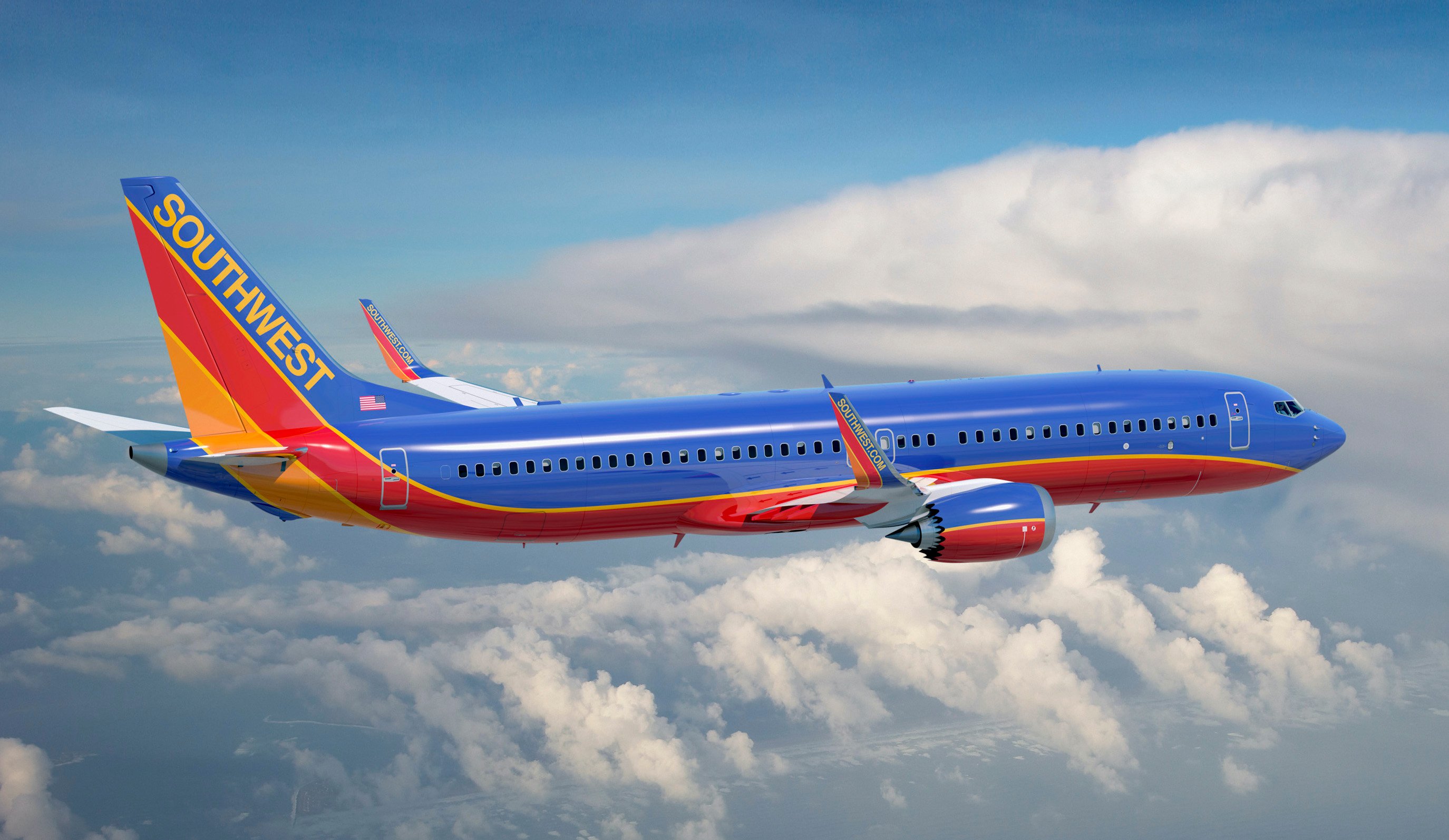 A Boeing 737 MAX airliner in Southwest Airline's trade dress, shown in flight above clouds.