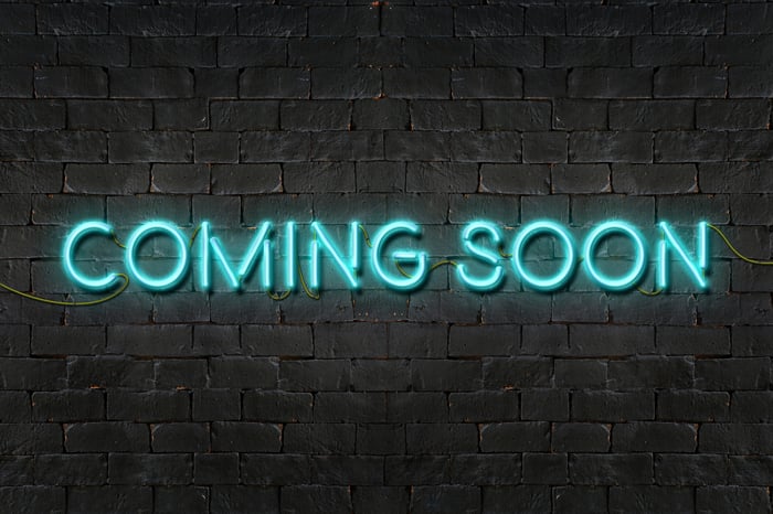 A neon sign that says coming soon