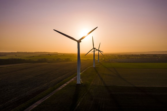 Three wind turbines at sunrise.