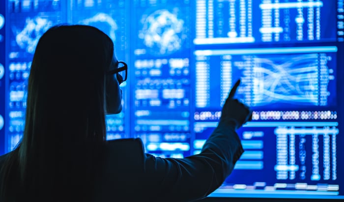 A businesswoman working with a display showing data analytics