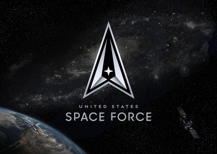 United States Space Force Logo with Earth, stars, and a satellite in the background