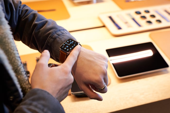 A customer trying on an Apple Watch in an Apple Store