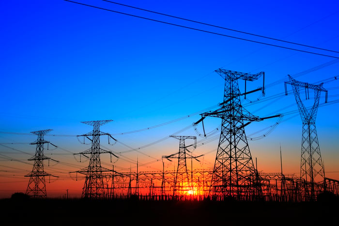 The silhouette of the evening electricity transmission pylon.