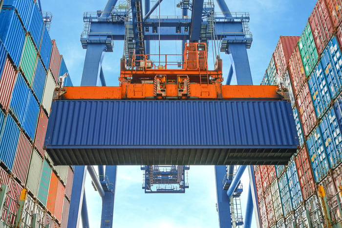 A shore crane moving shipping containers. 