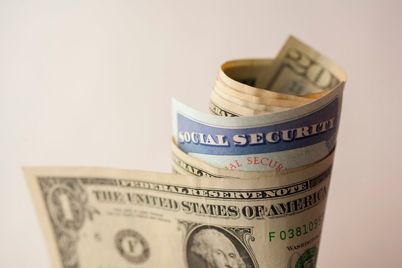 Social Security card folded into a money roll.
