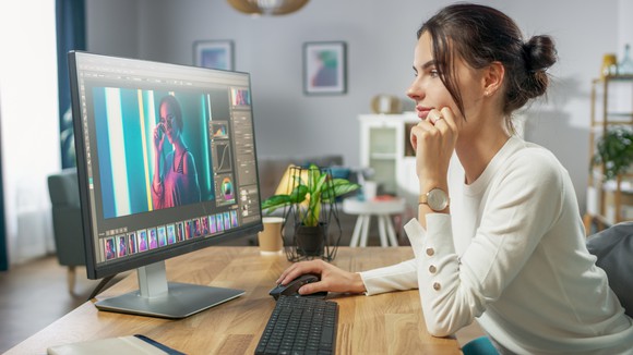 female editing a photo at her computer