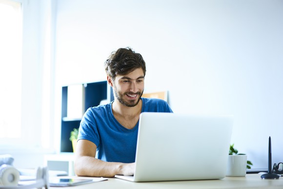 Smiling man at laptop