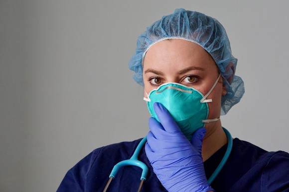 Healthcare professional wearing a mask and gloves