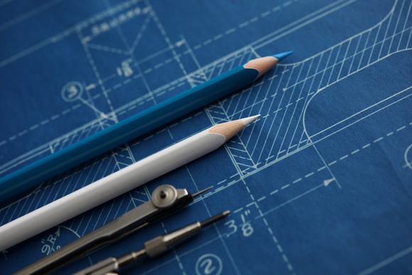 A blueprint with pencils on top.