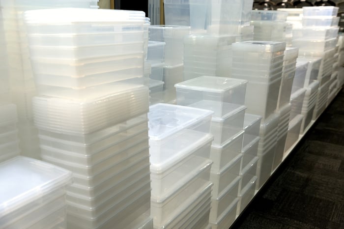 Stacks of clear plastic storage bins.