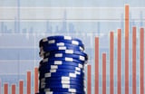 Blue poker chips on stock market background