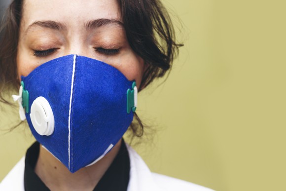 Doctor with closed eyes and mask on